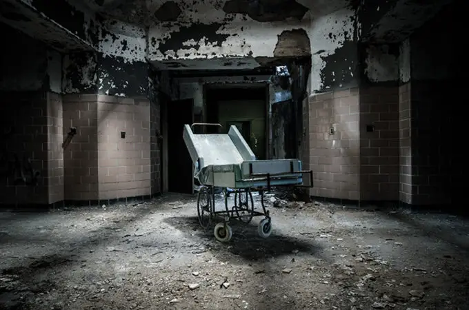 A Dark and Deserted Asylum Sits Quietly Falling to Pieces